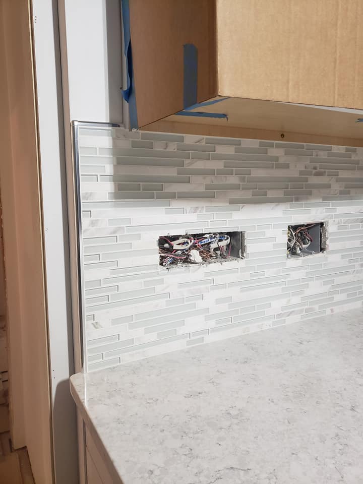 White glass and porcelain interlocking mosaic backsplash with steel edge