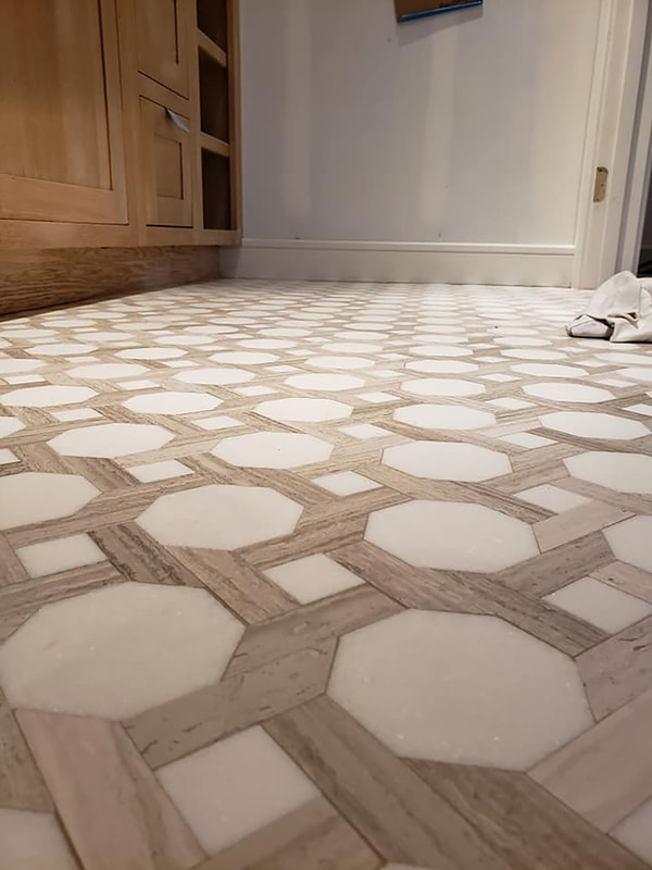 Close up white marble hexagon tile with wood look tile details