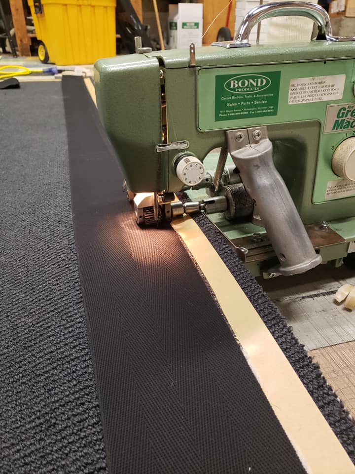 Sewing binding strip to carpet remnant to finish edges
