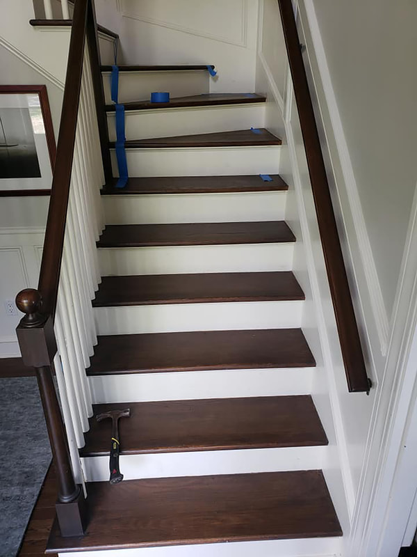 Bare wooden stairs being prepped for stair runner installation