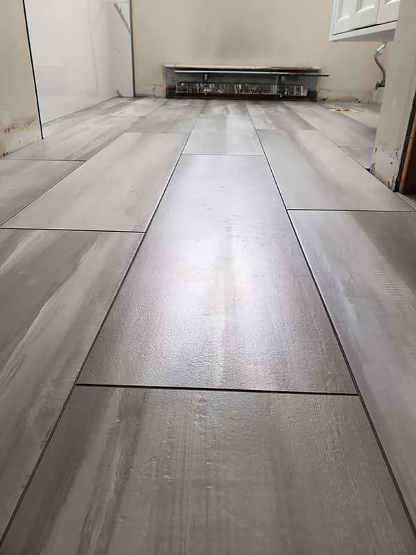 Gray wood-feel tile flooring installation
