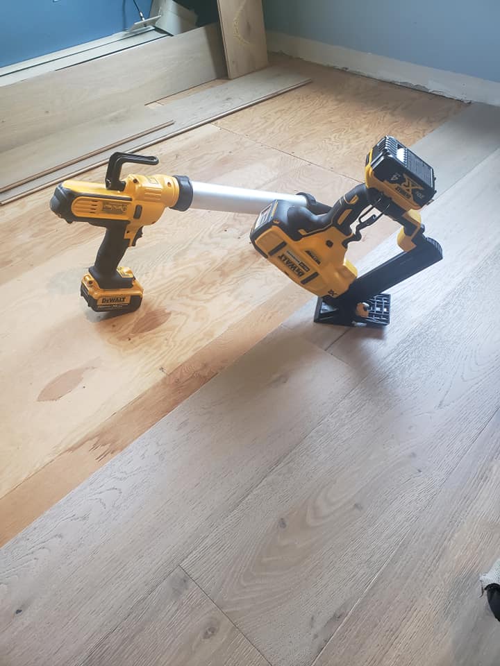 Flooring tools on wood floor in the process of being installed
