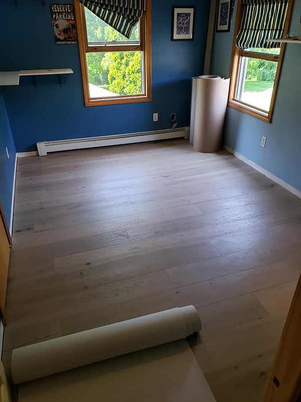Completed wood flooring in blue room