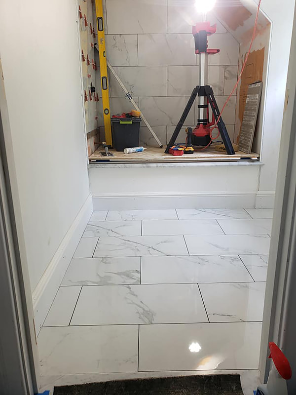 Bathroom remodel in progress with custom shower and marble tiles
