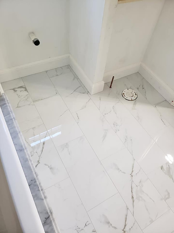 Marble tile installed on floor before toilet install