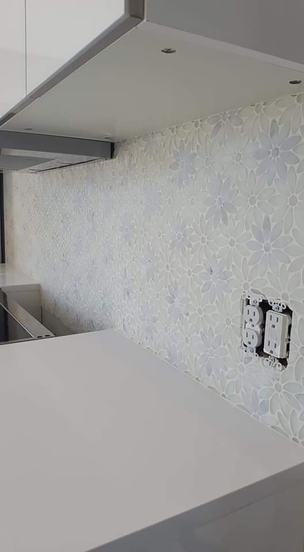 Finished white flower backsplash above kitchen counter