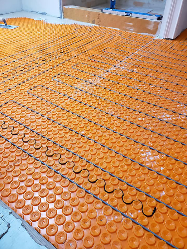 Installation of heating floor mat before tile installation