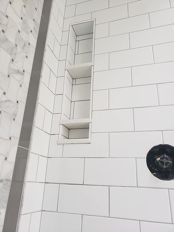 Shower niche close up with multiple shelves