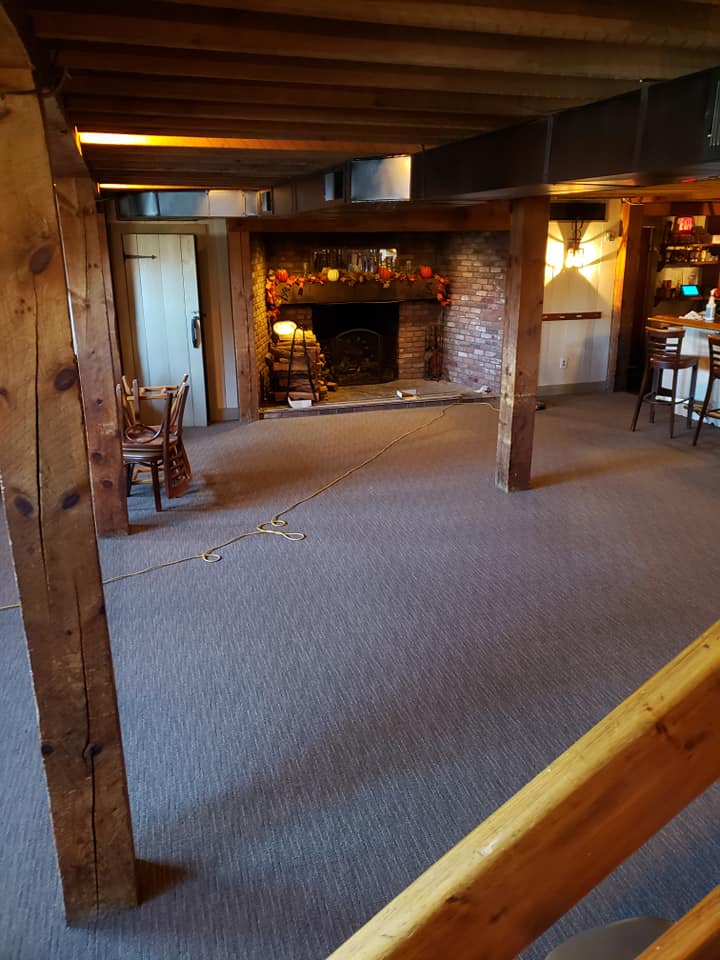 Carpet installation in bar and restaurant in front of fireplace